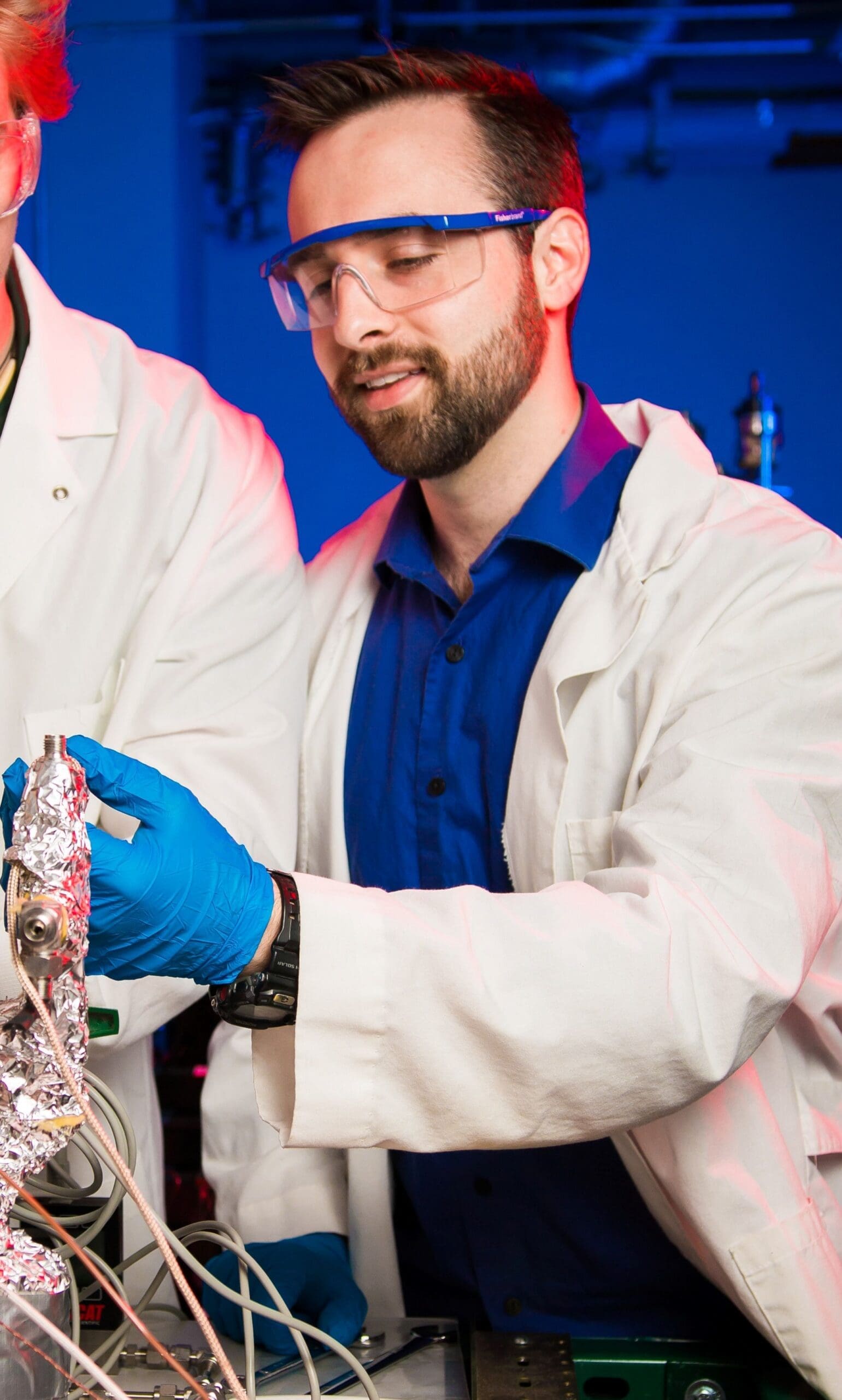 Scientist in lab coat conducting an experiment.