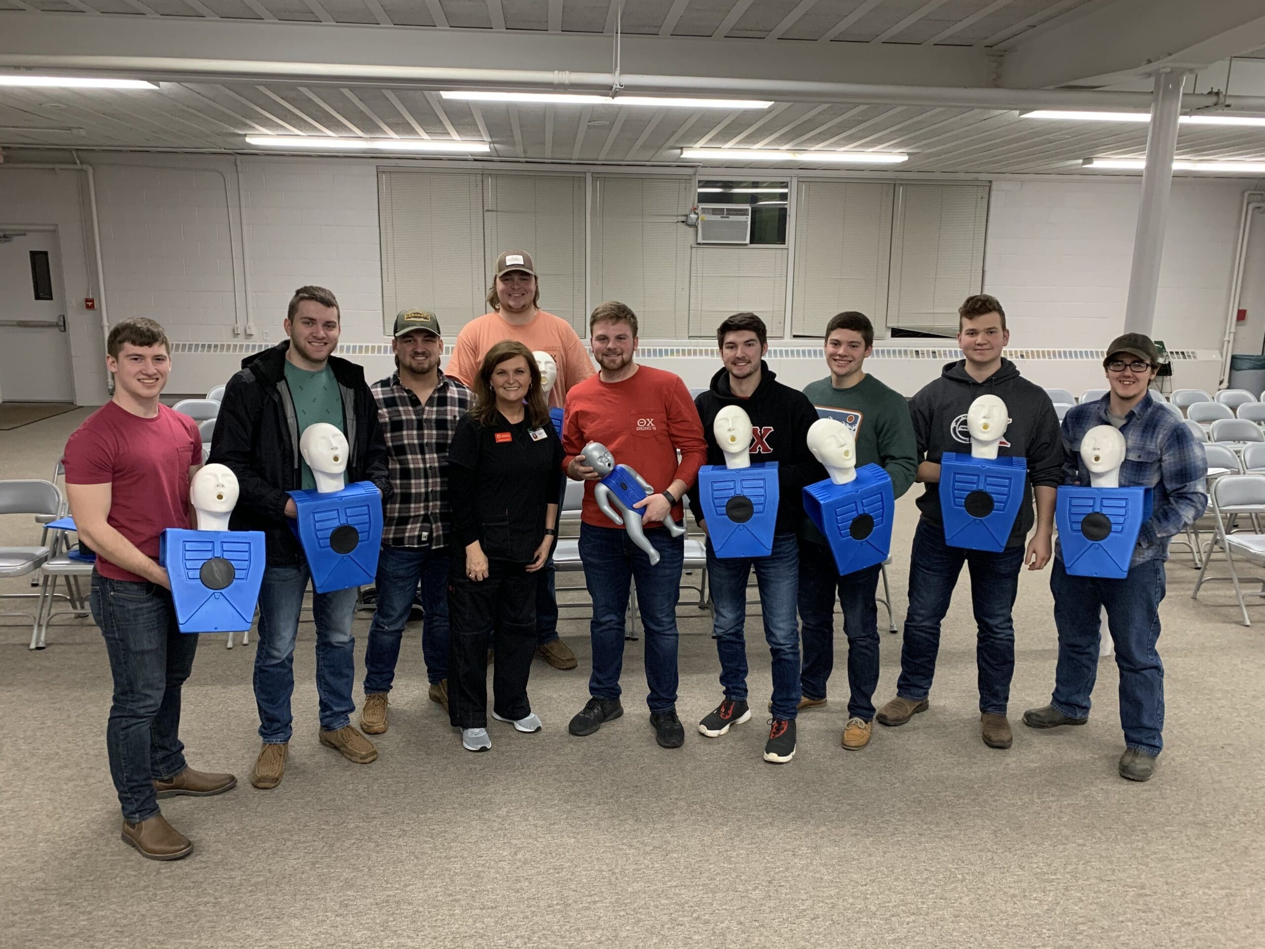 Group training session with CPR mannequins and instructors.