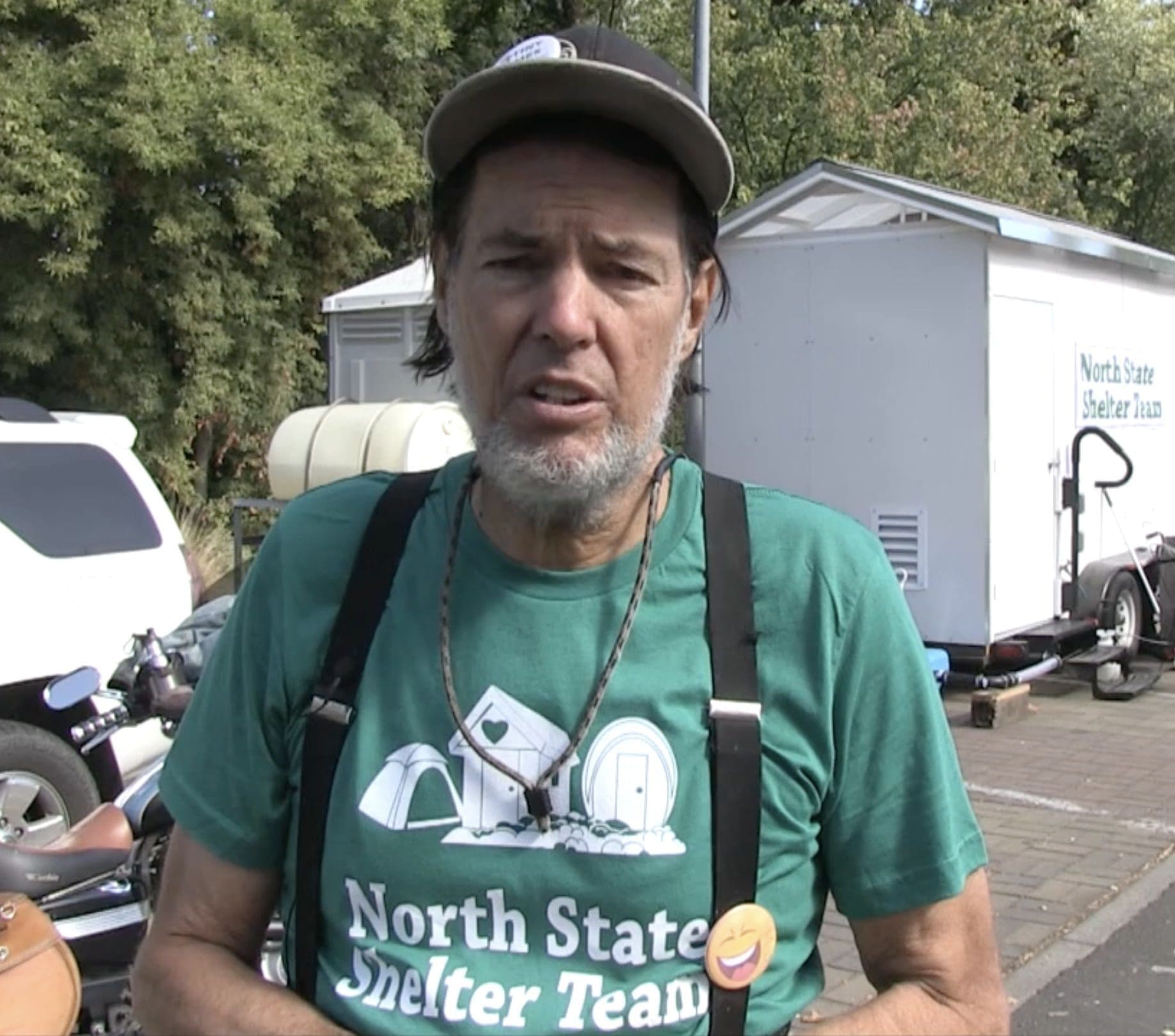 Man in green shirt promoting shelter team.