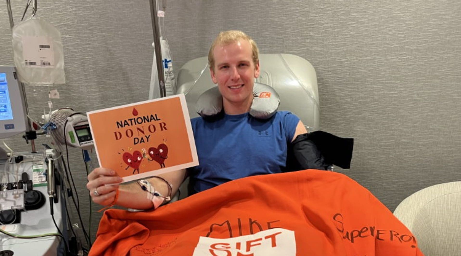 Young man celebrating National Donor Day while donating blood.