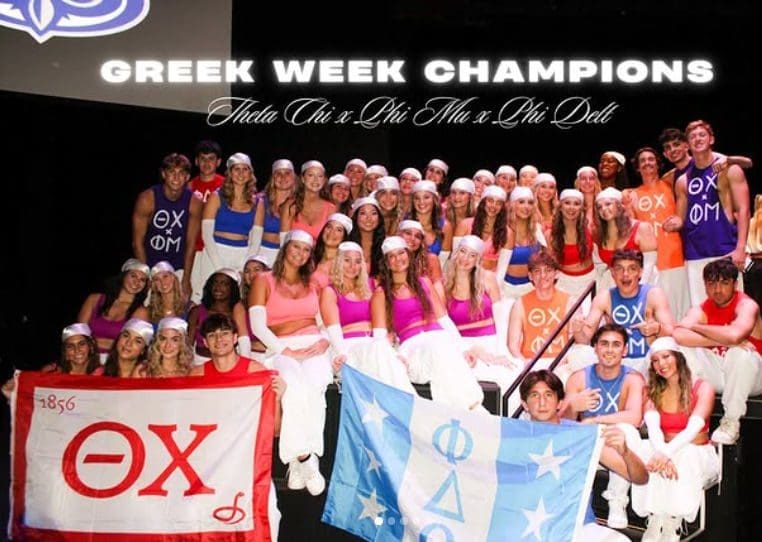 Greek Week champions celebrating with flags and costumes.