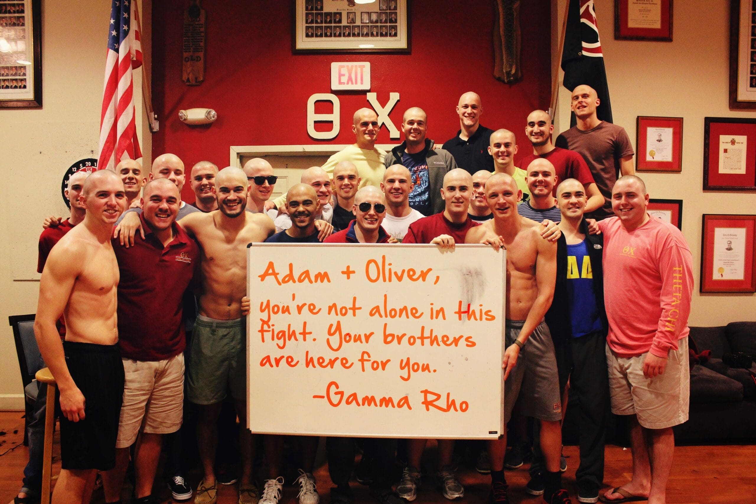 Group of supportive friends with shaved heads.