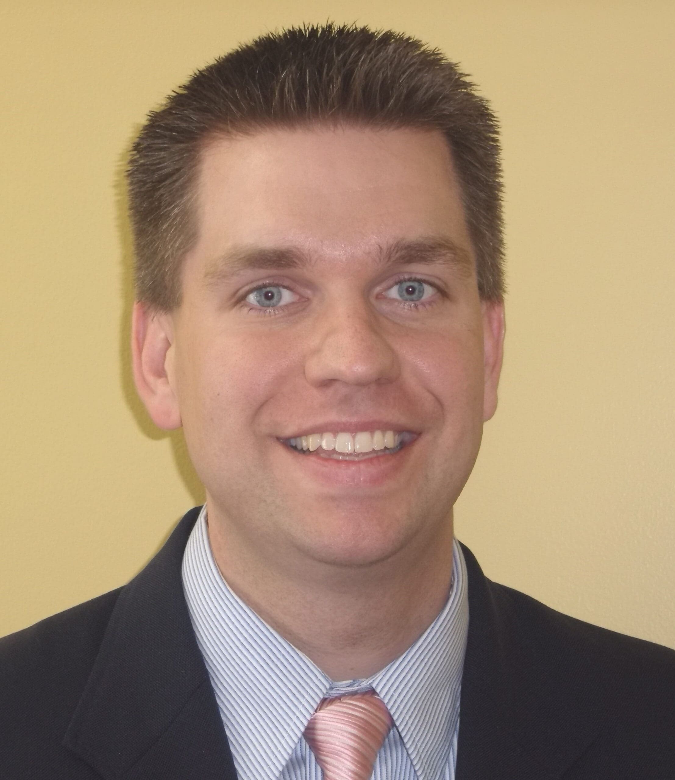 Smiling professional man in a suit and tie.