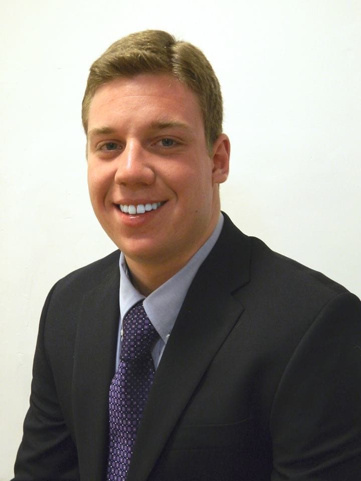Smiling young man in a suit and tie.