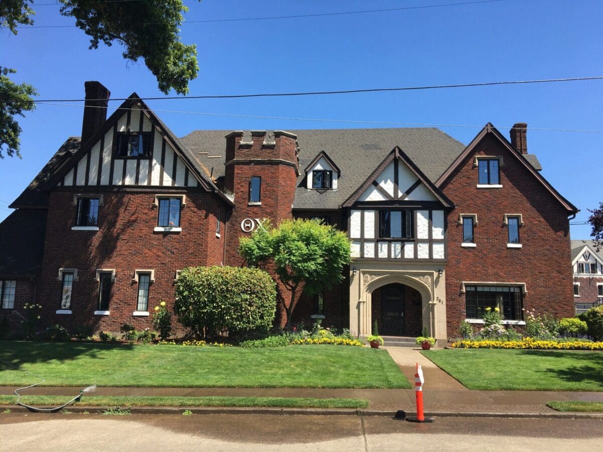 Historic brick Tudor-style mansion with landscaped garden.