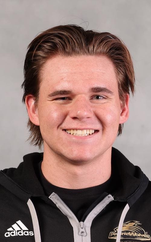 Smiling young man with short brown hair.