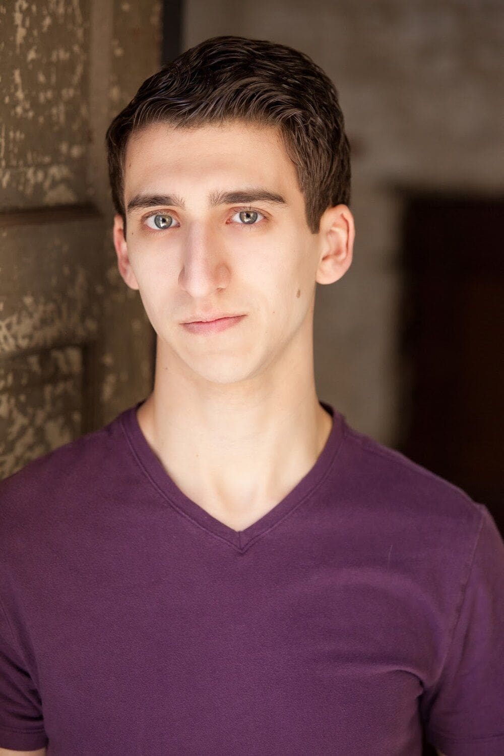 Stephen Kallas Young man in purple shirt with neutral expression.