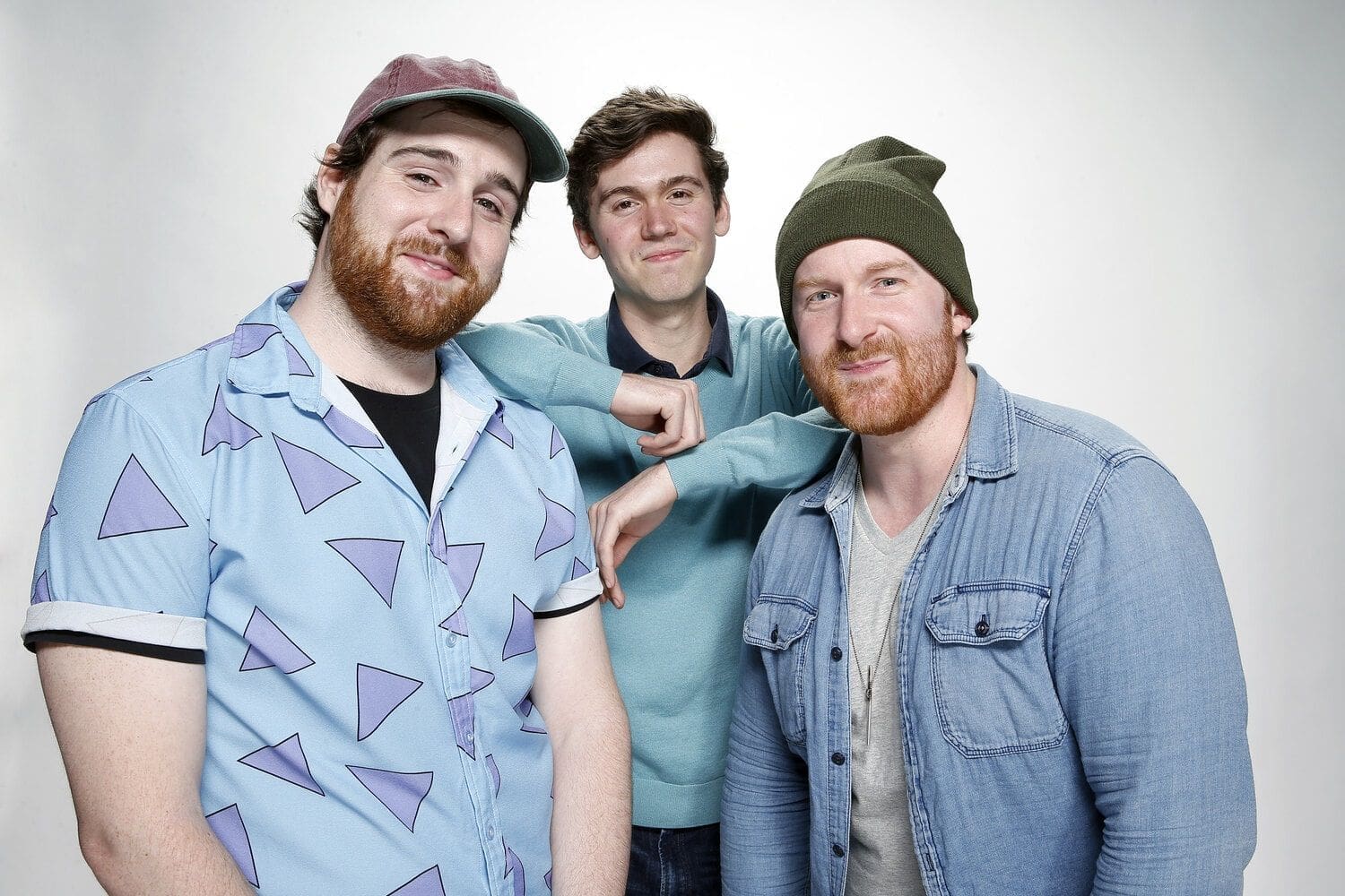 T.3 Three young men posing together in casual attire.
