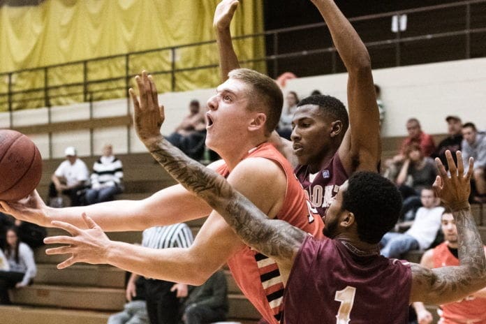 Basketball players competing for a rebound in action.