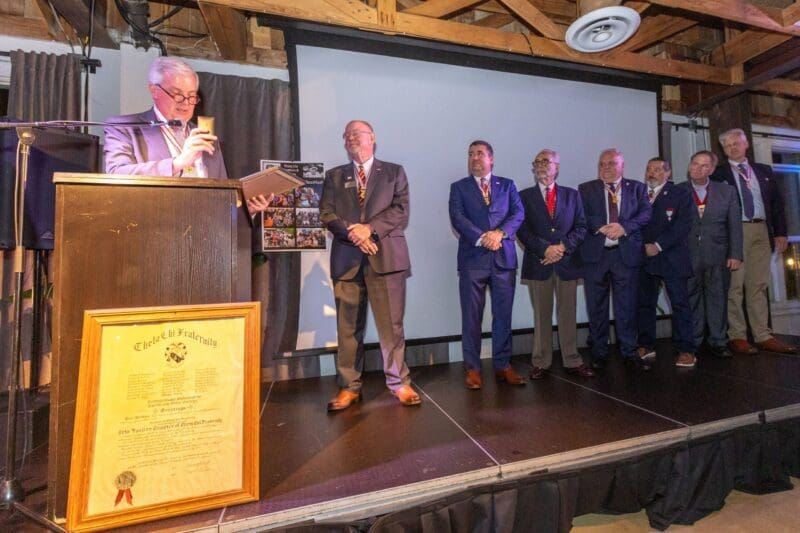 Award ceremony with speakers and honorees on stage.
