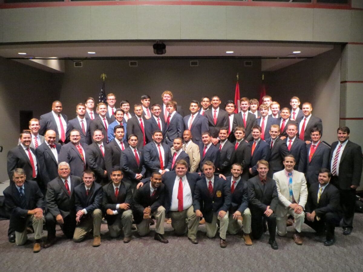 Group photo of fraternity members in formal attire.