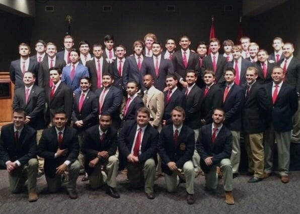 Group of young men in formal attire at event.