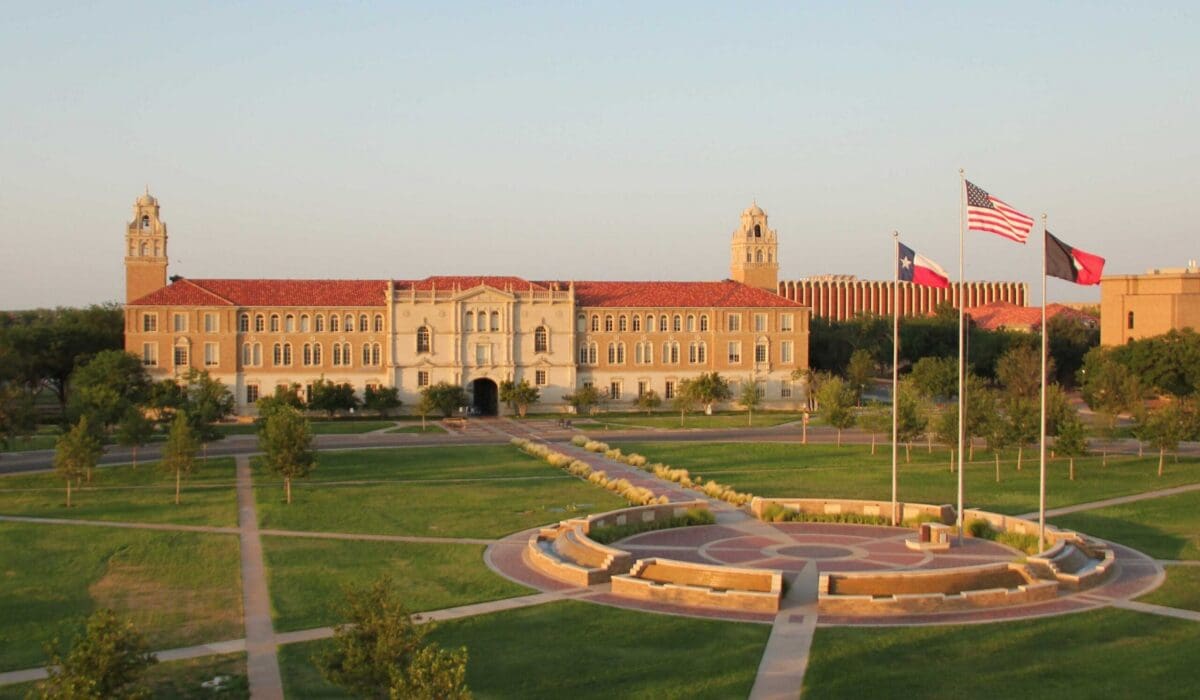 Texas Tech University campus with flag and landscaping.