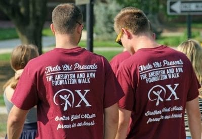 Participants in Theta Chi charity walk wearing matching shirts.