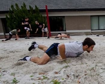 Athletes training in sand for improved performance.