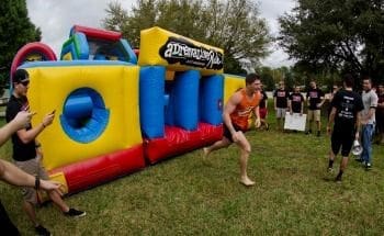 Person running towards inflatable obstacle course.