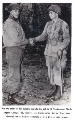 Soldiers shaking hands in historic military photo.
