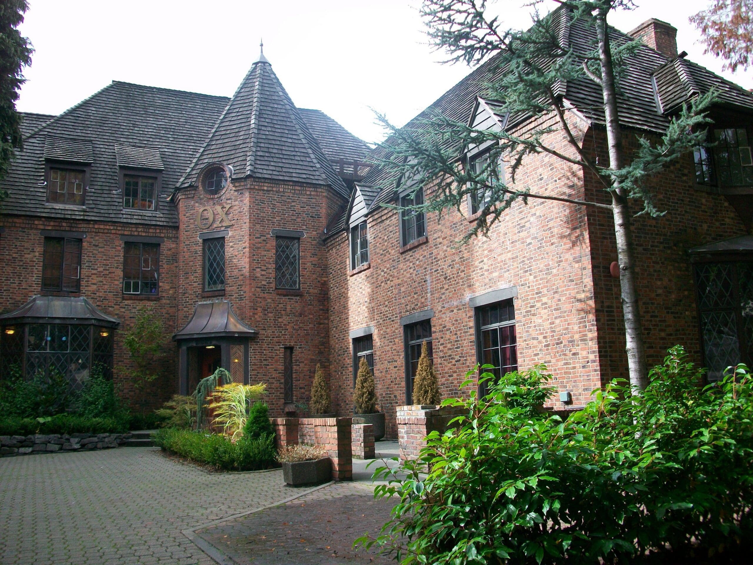 Alpha Rho House Historic brick house with landscaped garden.