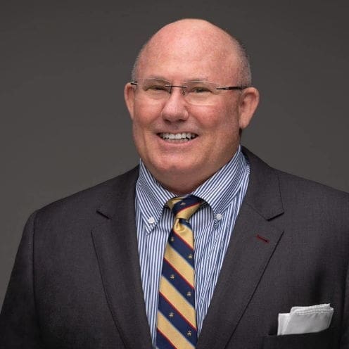 Smiling man in a suit and tie portrait.