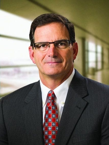 Business professional in glasses and suit.
