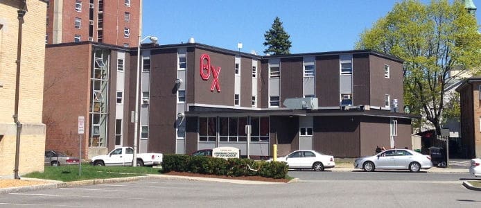 Brown building with large red letters "OX" visible.