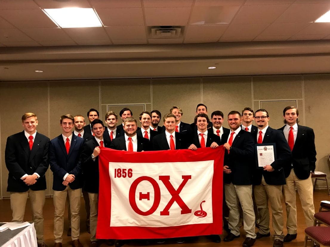 Young Harris Colonization Group of fraternity members with flag and certificates.
