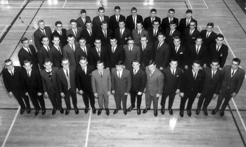 Group of men in suits posing indoors.