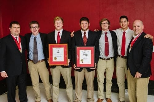 Group of young men celebrating academic achievements.