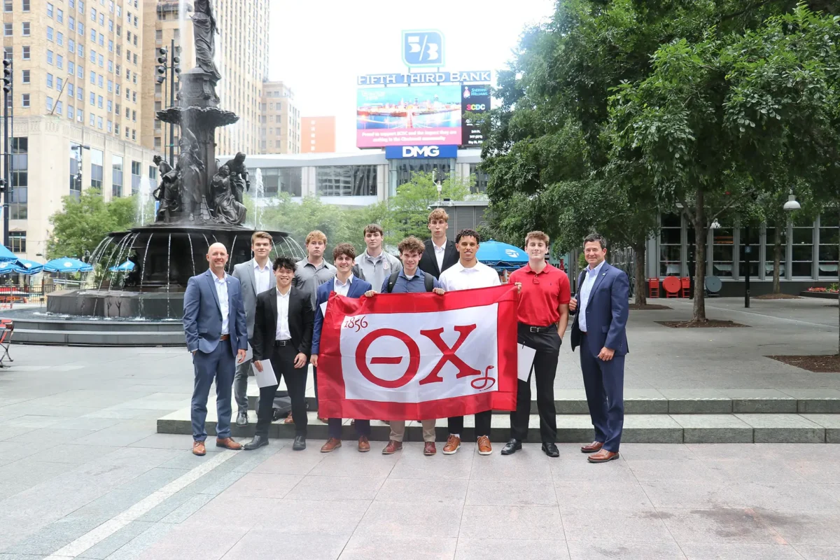 Theta Chi brothers holding their flag in Cincinnati