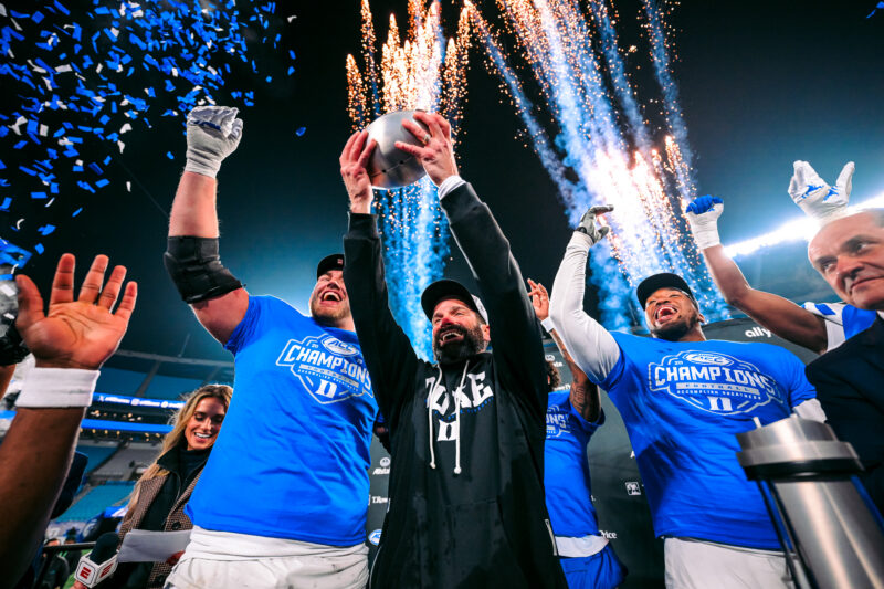 Manny Diaz celebrating with a trophy