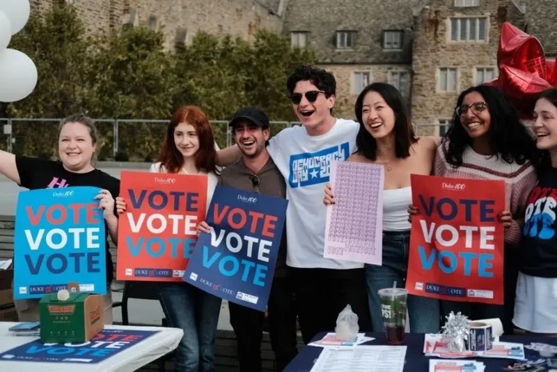 Mick Tobin with a group of people holding VOTE signs