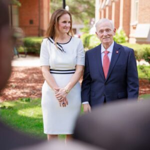 A man wearing a suit and a woman wearing a dress