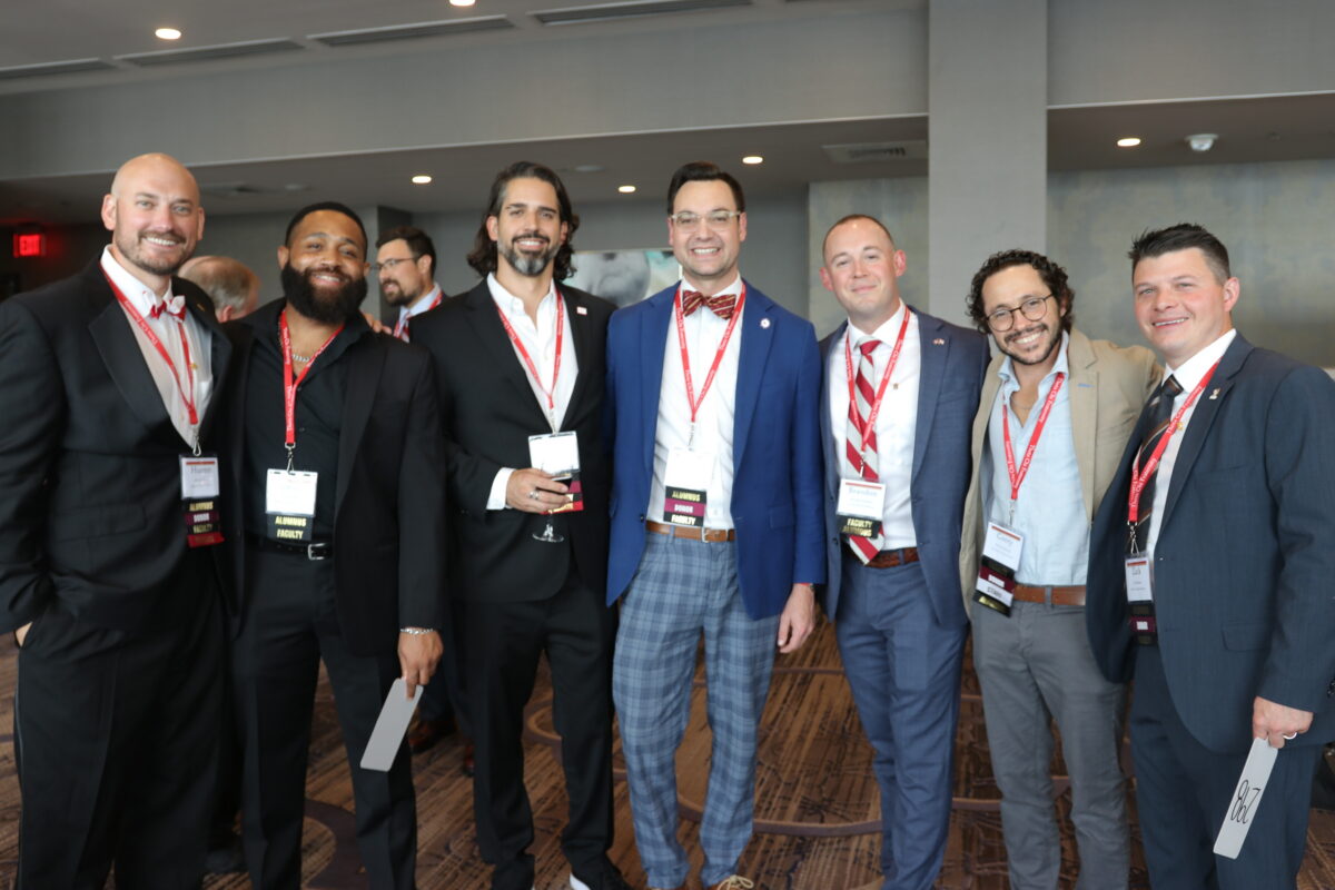 Brothers standing together at the Foundation Chapter auction.