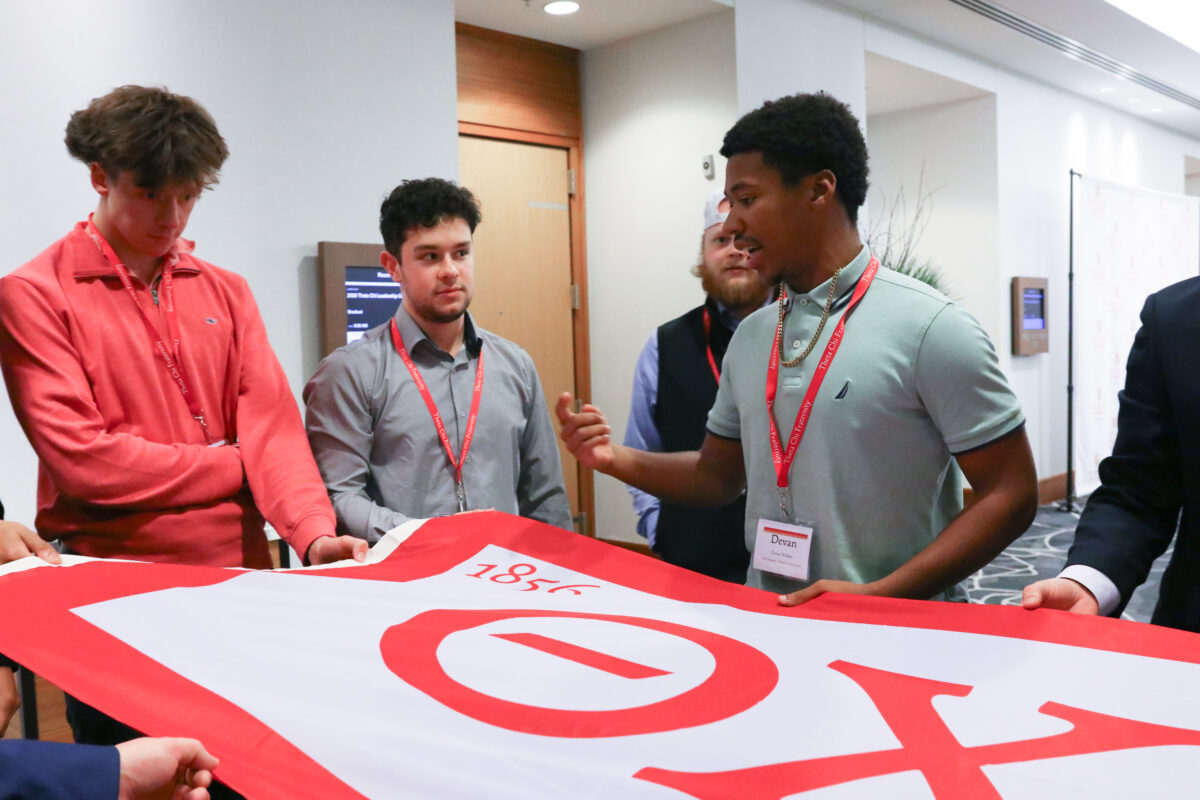 Brothers holding the flag during the Marshalls Summit