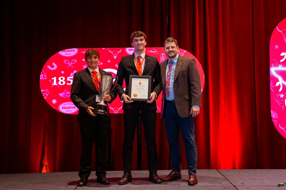 Epsilon Kappa/Idaho collegians standing next to Dr. James Black with their GC Scholarship Award.