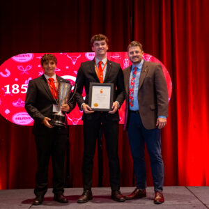 Epsilon Kappa/Idaho collegians standing next to Dr. James Black with their GC Scholarship Award.