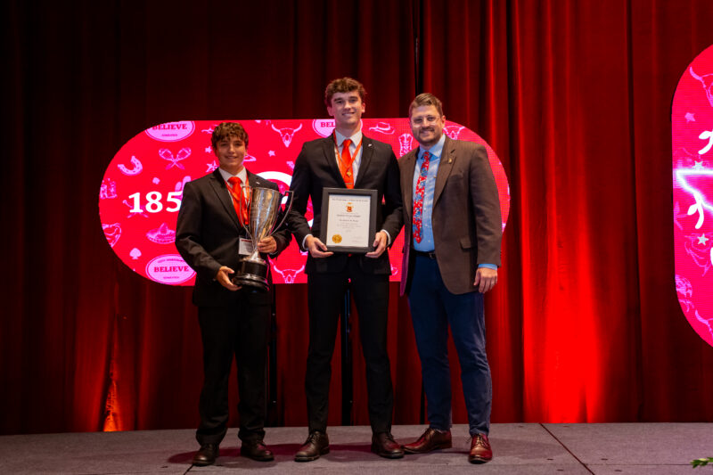 Epsilon Kappa/Idaho collegians standing next to Dr. James Black with their GC Scholarship Award.